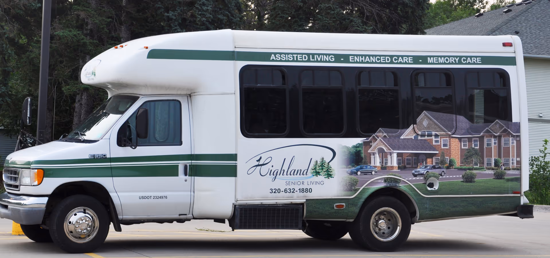 A white Highland Senior Living shuttle bus with green stripes and facility graphics parked outdoors.