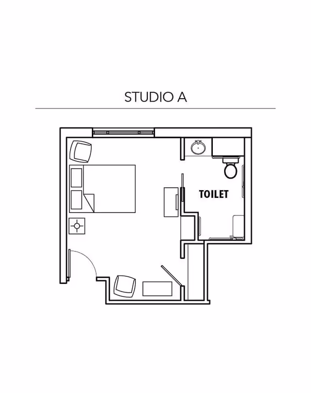 Architectural floor plan labeled Studio A showing a studio apartment layout with a bed, two chairs, a small table, and a separate toilet room with a sink and toilet.