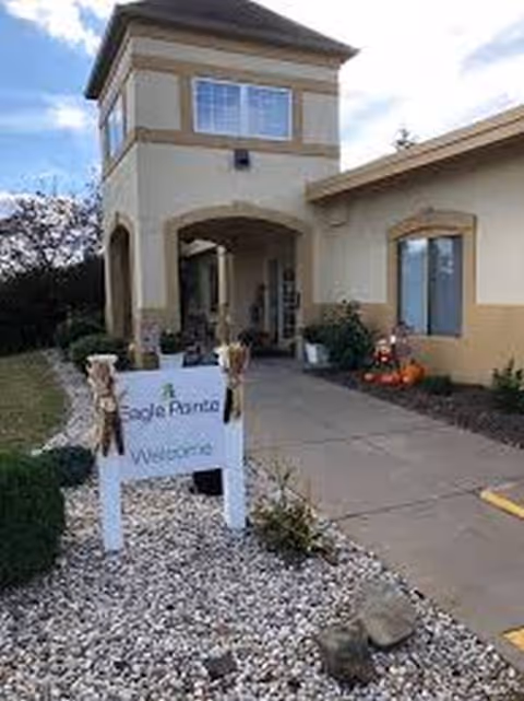 Exterior view of Eagle Pointe Healthcare Center entrance with sign and landscaping.