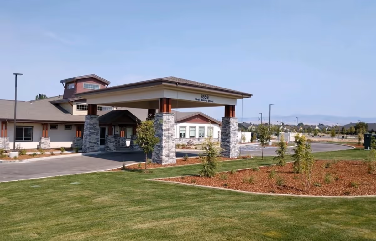 Exterior view of Foxtail Senior Living entrance with porte-cochère and landscaped lawn.