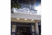 Front entrance of the Sutton Park Center for Nursing and Rehabilitation showing the building facade and signage above the doorway.