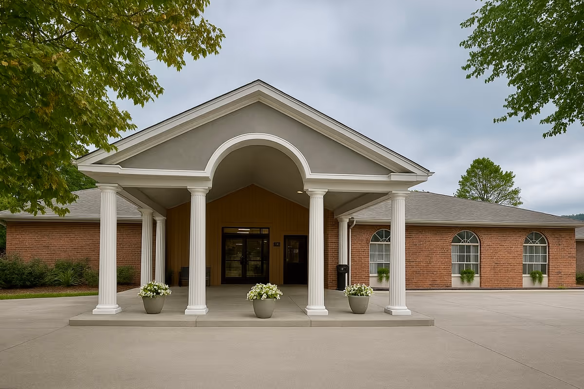 Front entrance of Decatur Wellness & Rehabilitation Center featuring columns and landscaped pots.