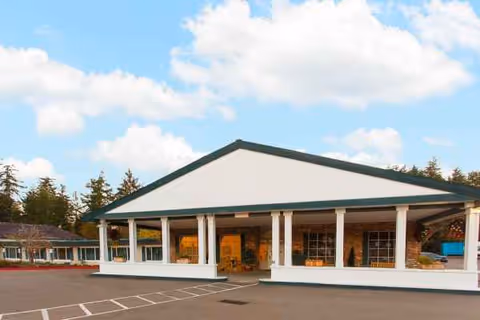 Front view of a single-story senior living center with white columns and a covered entry.
