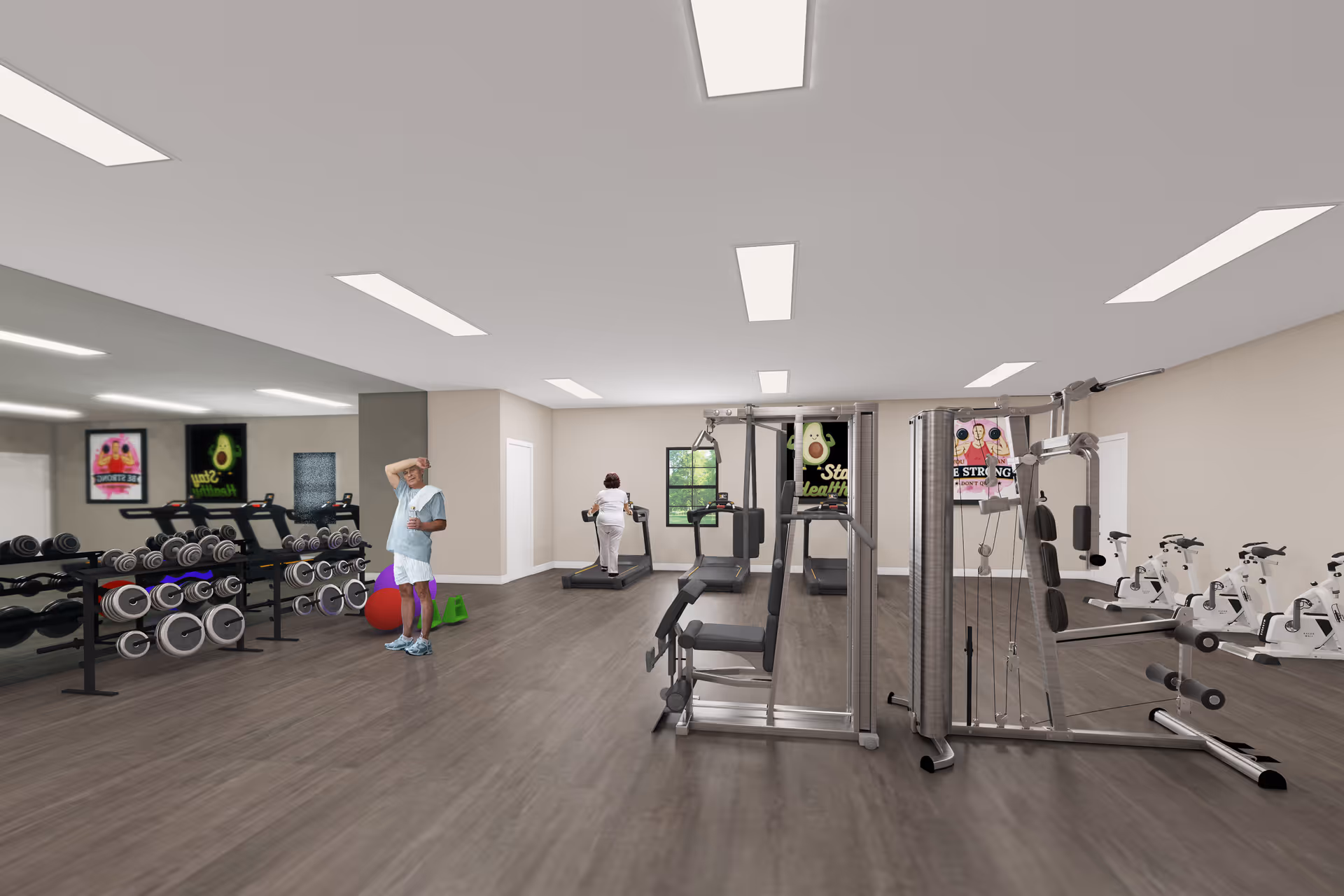 A fitness room in a senior living facility with exercise equipment including treadmills, stationary bikes, weight machines, and free weights. Two seniors are using the equipment, one walking on a treadmill and another standing near the weights. The room has large mirrors on one wall, light-colored walls, and bright overhead lighting. Motivational posters are visible on the walls.