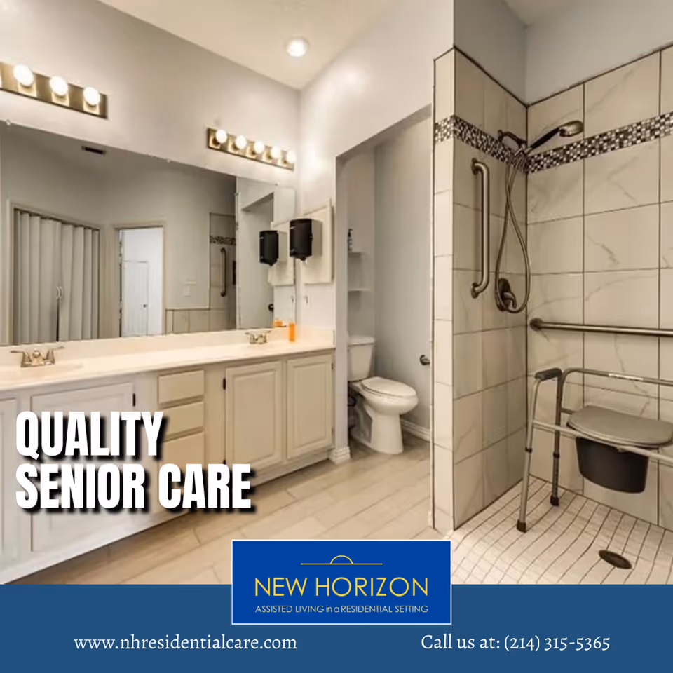 A spacious bathroom with a large mirror above a double sink vanity, a toilet in a separate alcove, and a walk-in shower equipped with grab bars and a shower chair, designed for accessibility.
