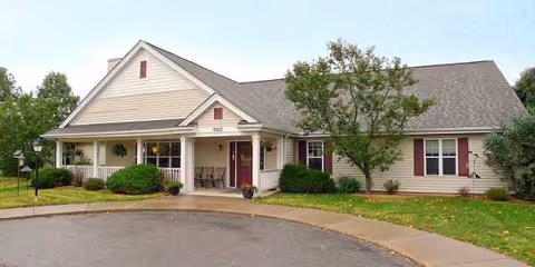 Single-story Our House Senior Living building with a covered front porch and manicured landscaping