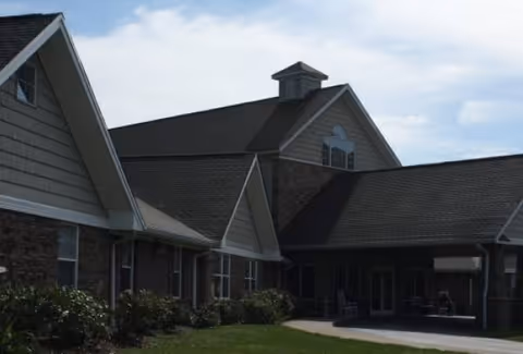 Exterior view of Eben Grace Adult Family Home showing brick and siding with an entry walkway.