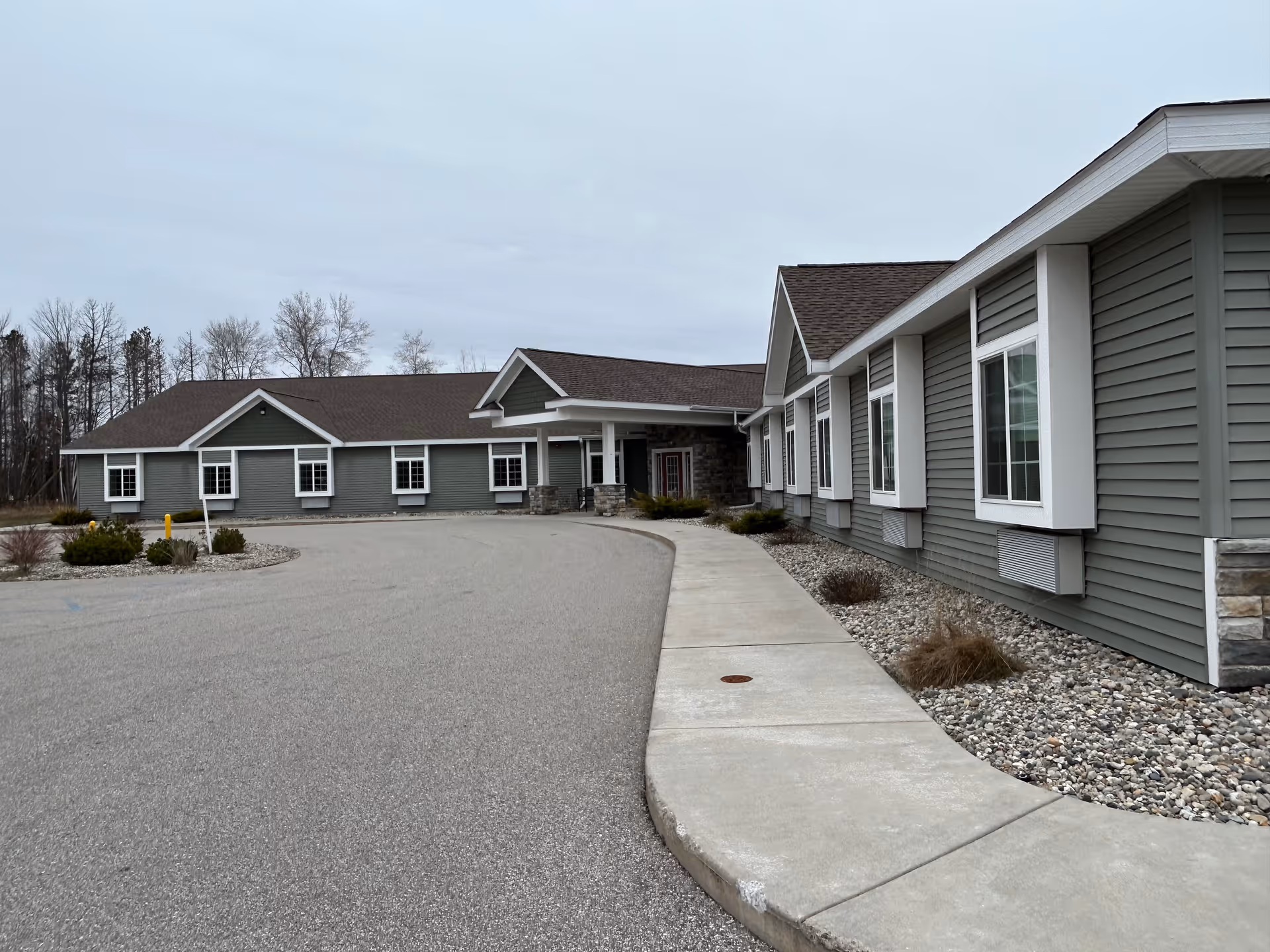 Exterior view of Coleman Fields Assisted Living & Memory Care facility with a curved driveway.
