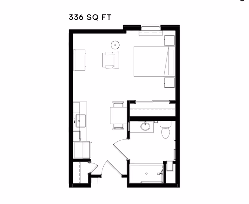 Floor plan of a 336 square foot studio apartment showing a combined living and sleeping area with a bed, chair, table, and kitchenette. The layout includes a bathroom with a sink, toilet, and shower.