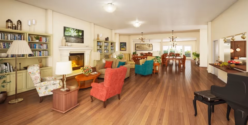 Bright, open communal living area with armchairs around a fireplace, dining tables in the back, and a piano.
