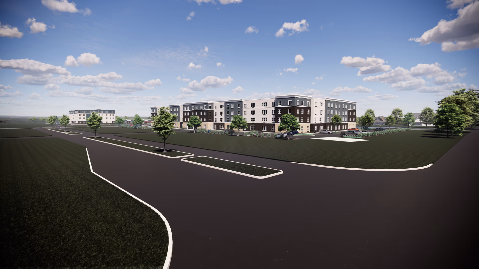 Wide exterior view of a modern multi-story senior living facility building with surrounding green lawns, trees, and paved roads under a partly cloudy blue sky.