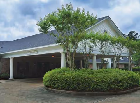 Exterior view of Forest Haven Nursing and Rehabilitation Center front entrance with trees and shrubs.