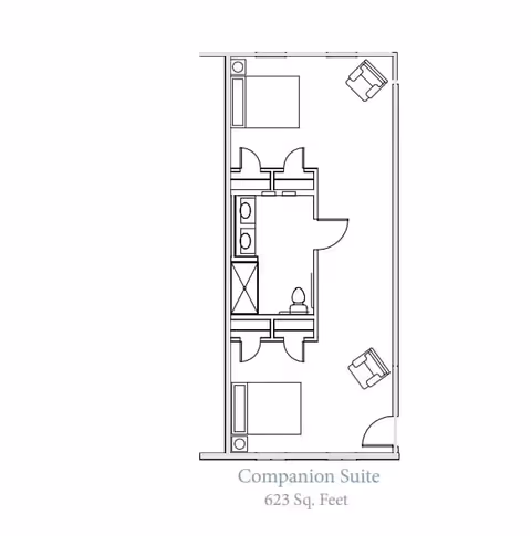 Architectural floor plan of a companion suite at Grand Brook Memory Care of Greenwood, showing two bedrooms each with a bed and nightstand, a shared bathroom with two sinks, a toilet, and a shower, and a living area with two chairs. The suite measures 623 square feet.