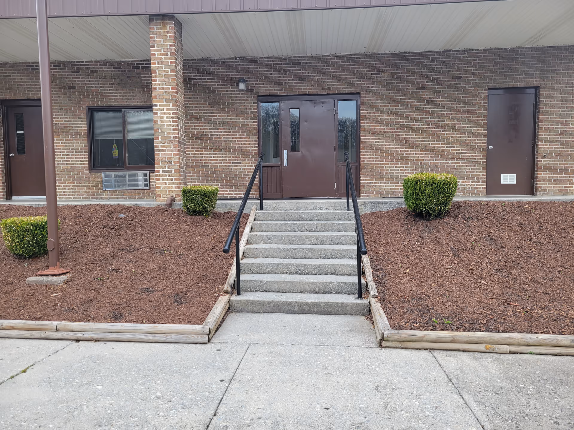Entrance with stairs and landscaping at Kingston Center Assisted Living