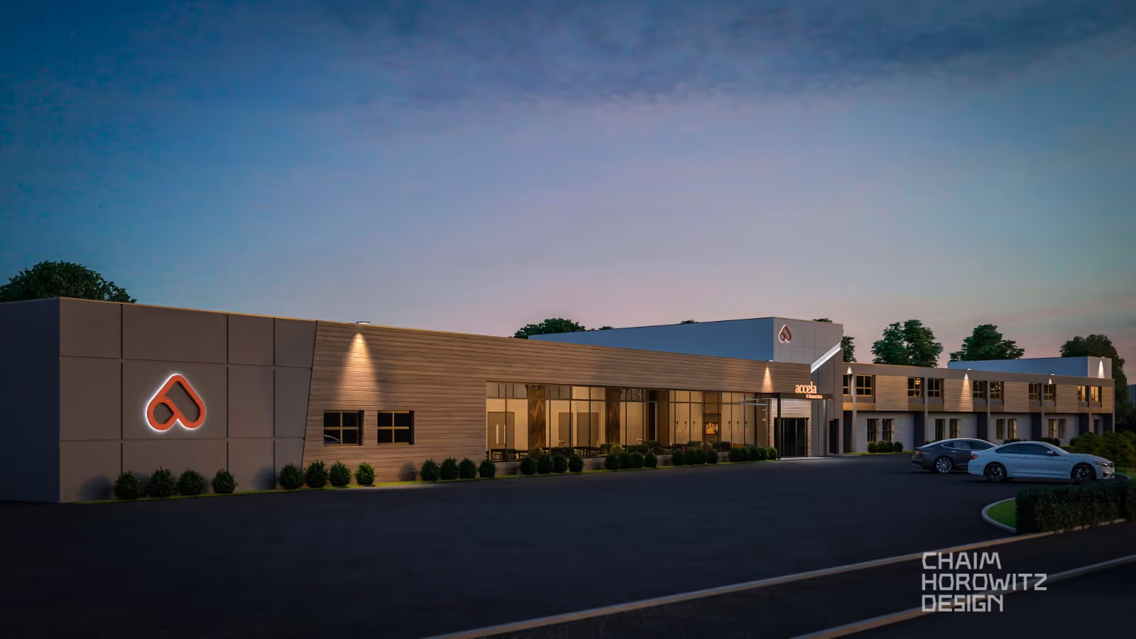 Modern single-story senior care building at dusk with parking lot and illuminated logo.