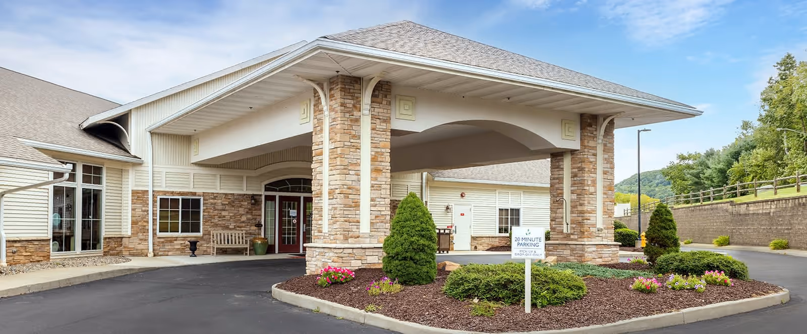 Exterior view of Brookdale Vestal West entrance with covered drop-off and landscaped grounds.