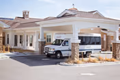 Exterior view of AltaVita Memory Centre entrance with a parked white van.