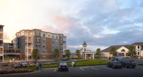 Exterior view of Oakwood Village Prairie Ridge with parked cars and landscaped entrance.