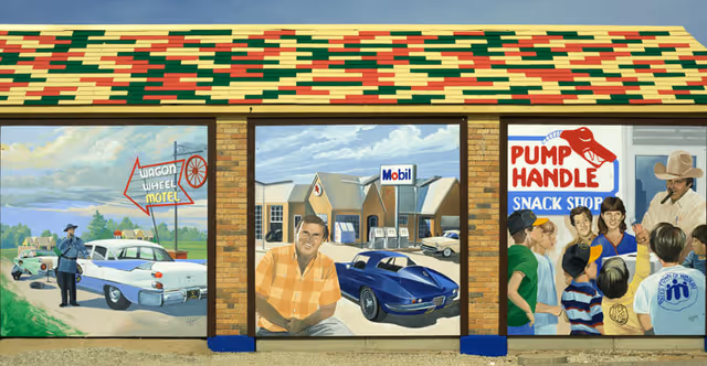 Colorful exterior mural on a building depicting three retro scenes: a motel with a police officer and classic car, a man in front of a Mobil gas station with a blue sports car, and a snack shop scene with people and a cowboy.