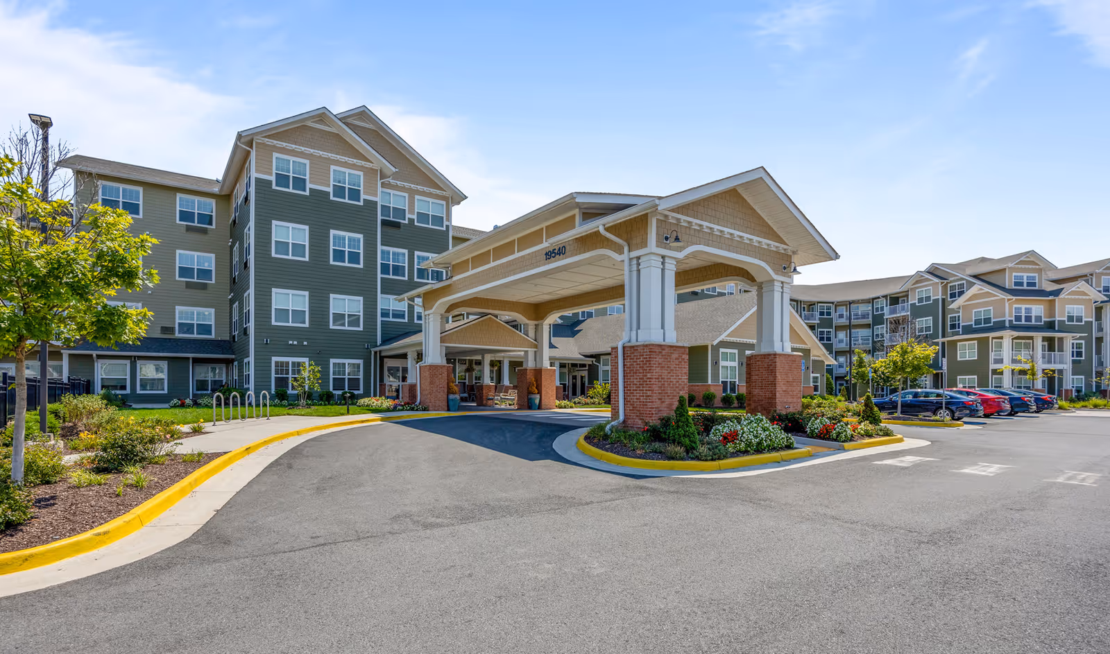 Exterior view of Hessler Heights Gracious Retirement Living with covered entrance and parking.