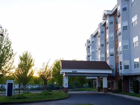 Front view of Cherrywood Village a Generations Community, a multi-story senior living building with covered entry.