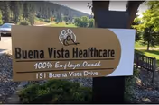 Outdoor sign for Buena Vista Healthcare with text stating 100% Employee Owned and the address 151 Buena Vista Drive, surrounded by trees and greenery.