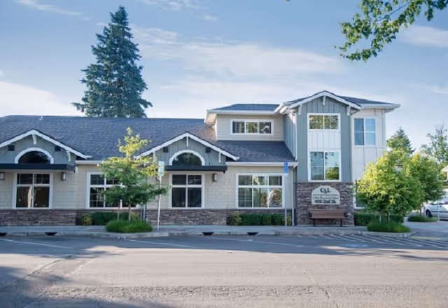 Exterior view of Countryside Living of Canby showing the facility front with trees and a sign.
