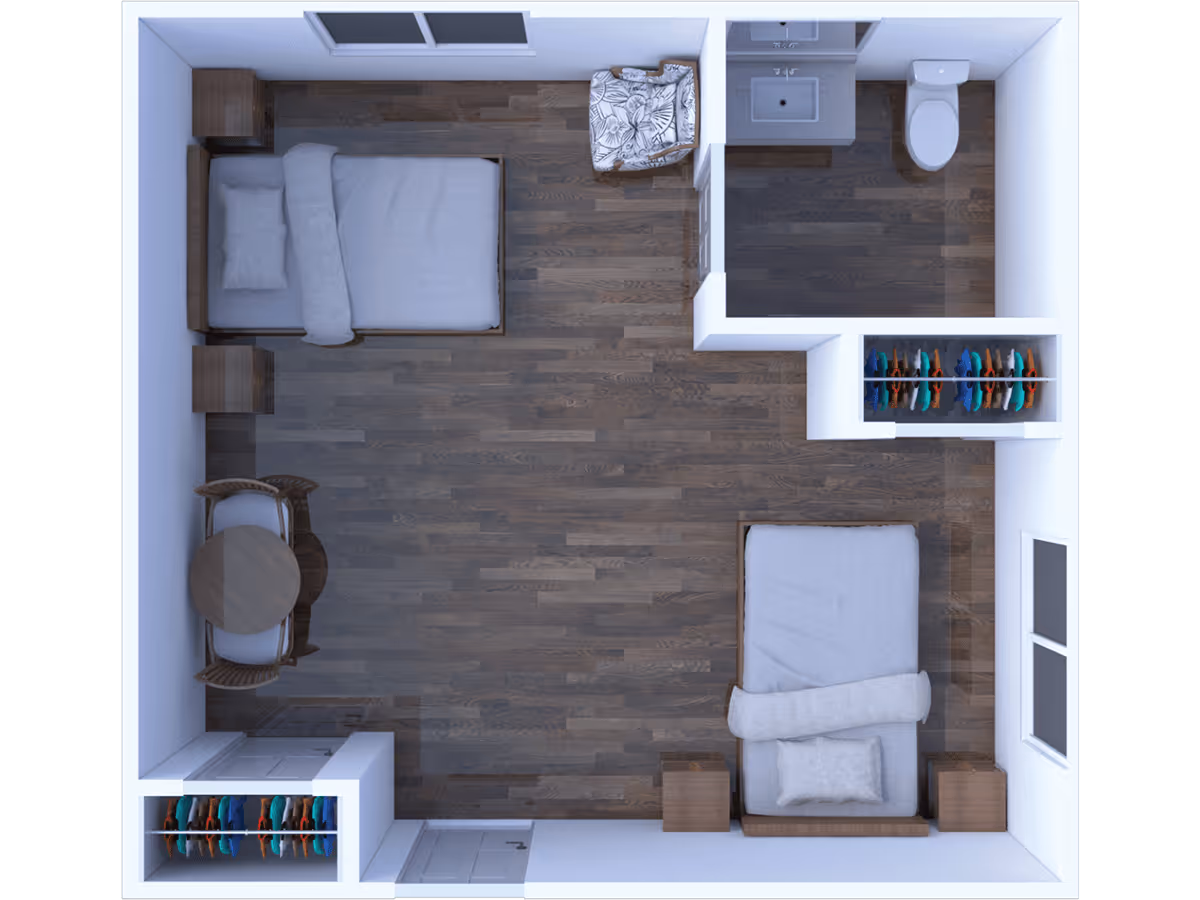 Top-down view of a floor plan showing a room with two beds, two closets with hanging clothes, a small round table with two chairs, a single armchair, and a bathroom with a sink and toilet.