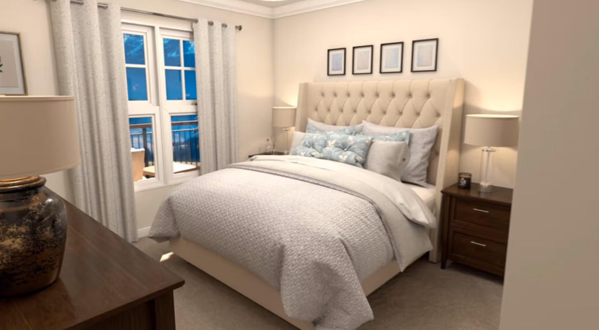 A cozy bedroom with a beige tufted headboard bed covered in white and light blue bedding and pillows. There are two wooden nightstands with lamps on each side of the bed. A window with white curtains shows an outdoor balcony with chairs. A wooden dresser with a decorative lamp is visible in the foreground.