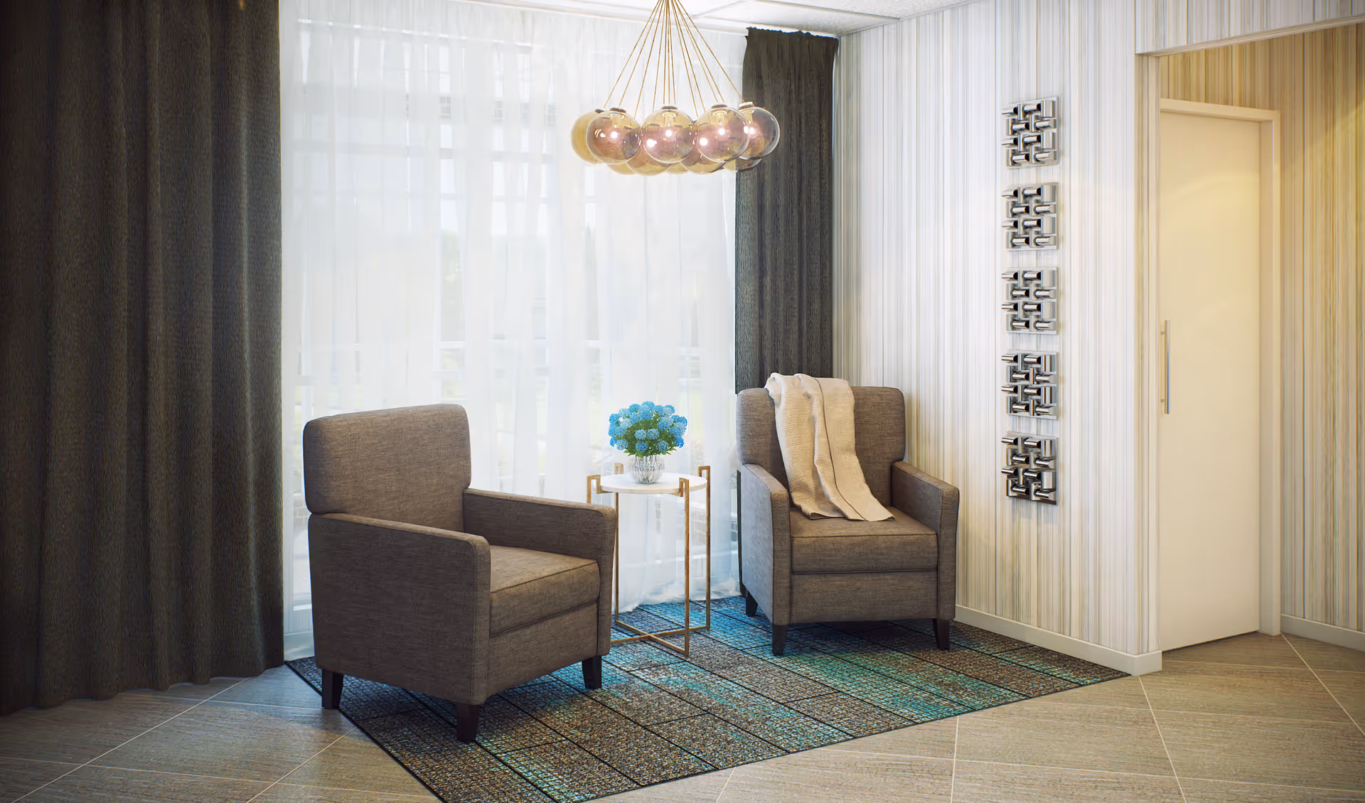 A cozy sitting area with two gray armchairs placed on a patterned rug in front of a large window with sheer white curtains and dark drapes. A small round side table with a vase of blue flowers is positioned between the chairs. A modern chandelier with multiple spherical lights hangs from the ceiling. The wall features vertical striped wallpaper and decorative square wall art, with a closed door visible on the right side.