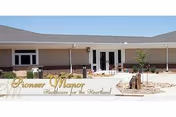Exterior view of Pioneer Manor at Stevens County Hospital entrance with landscaped front.