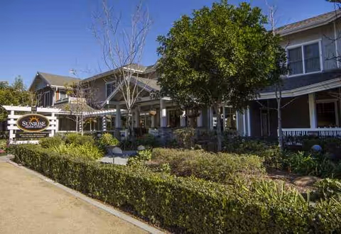 Exterior view of Ivy Park at Fullerton senior living facility with landscaped entry.