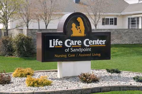 Exterior view of Life Care Center of Sandpoint sign with landscaped front yard