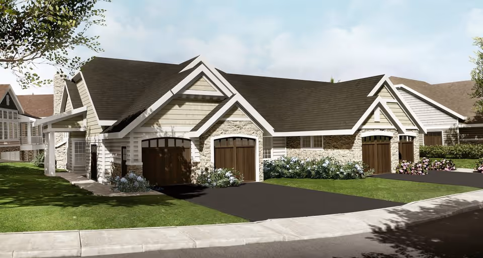 Exterior view of a senior living facility building with multiple garage doors, stone and siding facade, pitched roofs, and landscaped greenery including bushes and flowers along the driveway and lawn.