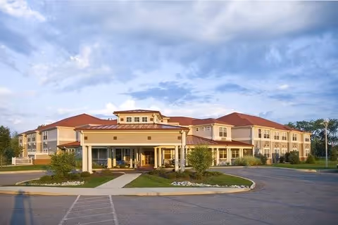Exterior view of SouthWest Commons by New Perspective, showing a multi-wing senior living building and entrance.