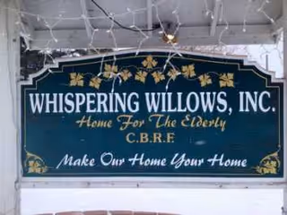 Exterior sign for Whispering Willows, Inc., senior living facility.