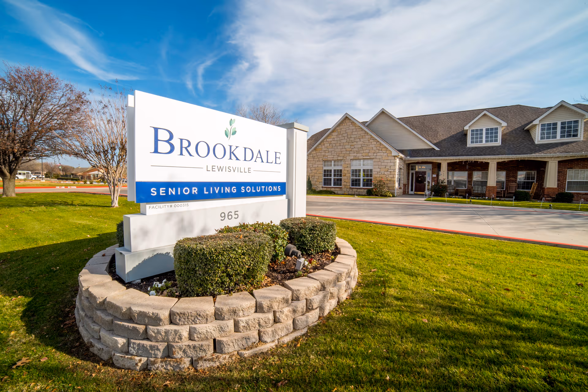 Brookdale Lewisville exterior with sign and brick-front entrance.