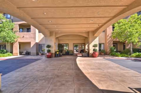 Covered entrance to Ivy Park at Roseville with columns, planters, and a wide walkway.