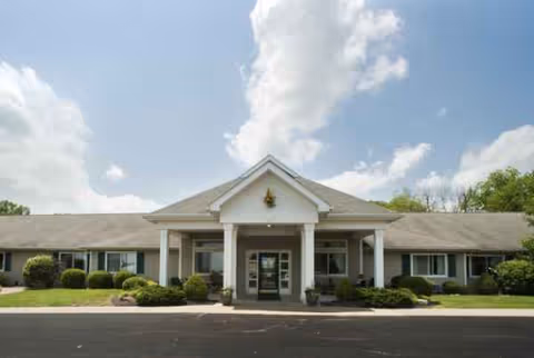 Front view of Cedar Creek of Washington senior living facility entrance with columns.