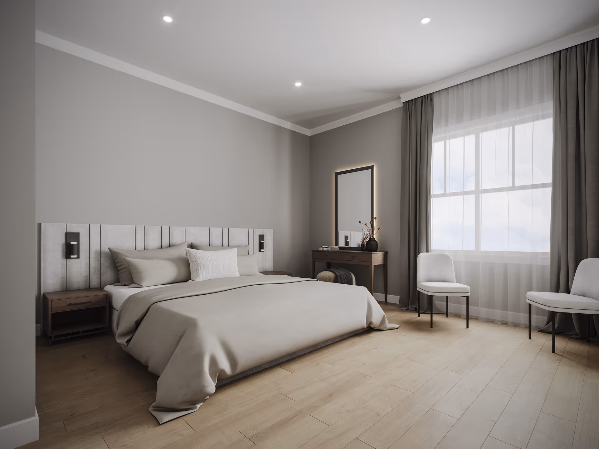 Bright, minimal modern bedroom with a large bed, bedside tables, a dressing table, and two chairs by a window.