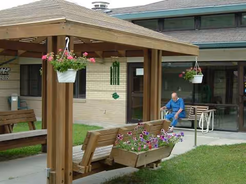 Outdoor seating area outside Blue Valley Lutheran Care Home with a resident seated.