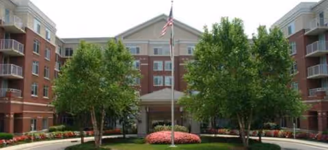 Front view of Brookdale North Raleigh senior living building with trees and landscaping.