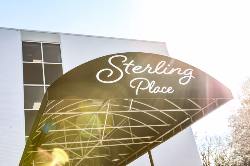 Exterior view of Sterling Place featuring a curved canopy over the entrance.