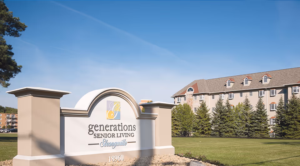 Entrance sign reading "generations SENIOR LIVING Strongsville" with the facility building and lawn behind it under a blue sky.