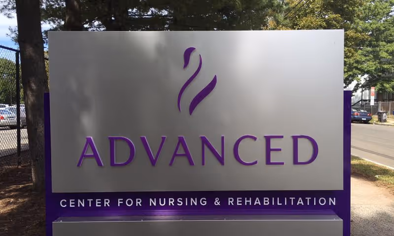 Outdoor freestanding sign reading 'ADVANCED' with 'Center for Nursing & Rehabilitation' in purple lettering.