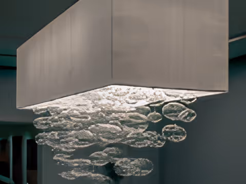 Modern rectangular ceiling light fixture with cascading bubble-like glass elements.