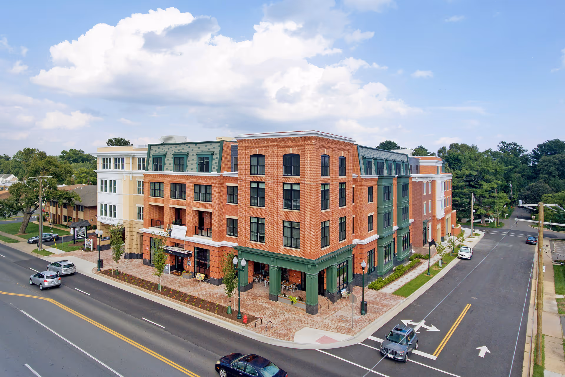 A multi-story senior living facility on a street corner with brick exterior.