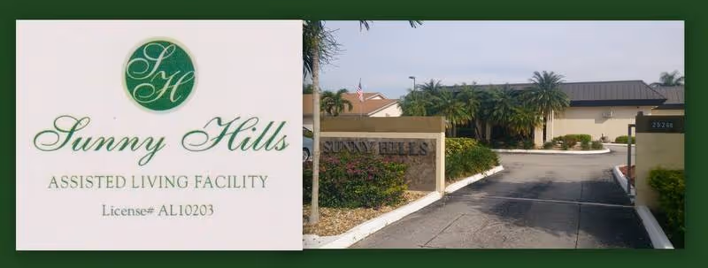 Entrance view of Sunny Hills Assisted Living Facility showing a driveway leading to the building with palm trees and landscaping on either side. On the left side of the image is a sign with the facility's name, logo, and license number.