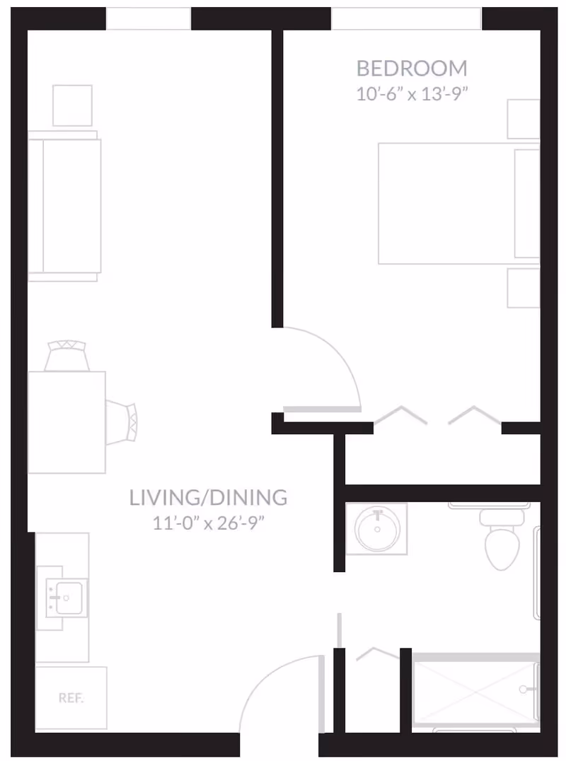 Floor plan layout of a one-bedroom apartment at Inspired Living Kenner, showing a bedroom measuring 10 feet 6 inches by 13 feet 9 inches, a combined living and dining area measuring 11 feet by 26 feet 9 inches, a kitchen area with a refrigerator and sink, and a bathroom with a sink, toilet, and shower.