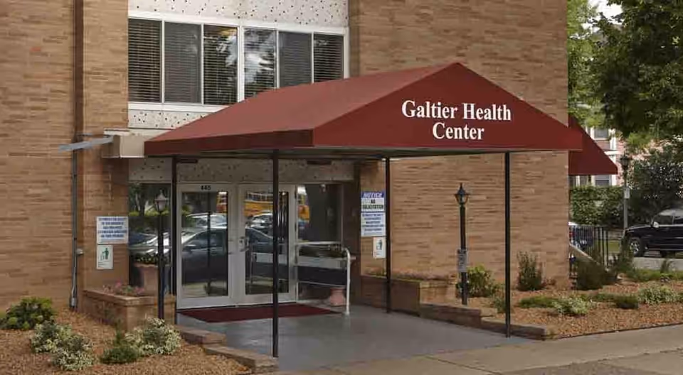 Brick building entrance with a red canopy labeled Galtier Health Center.